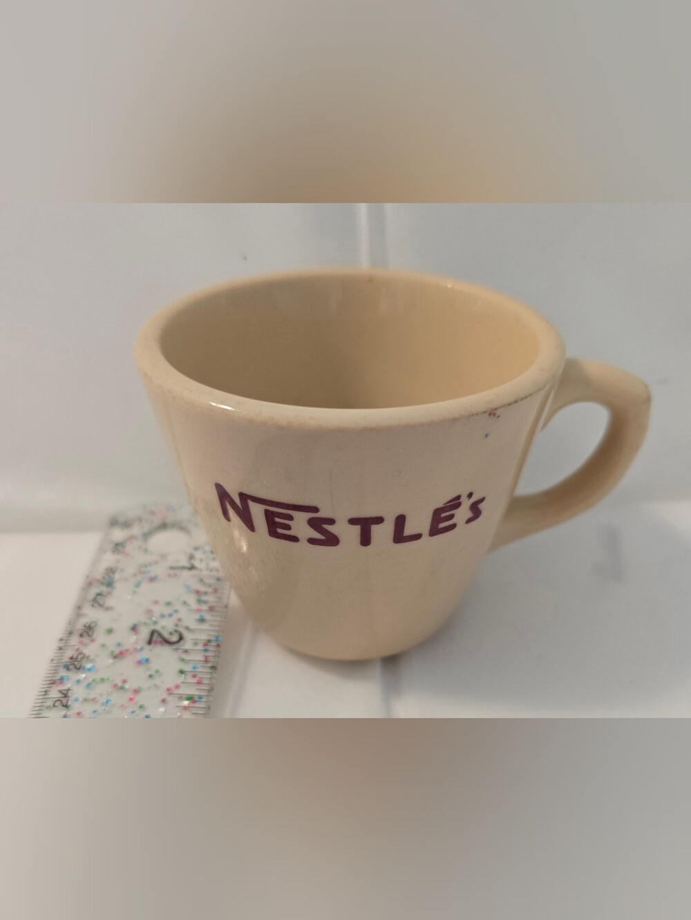 This is a vintage Shenango China “Inca Ware” Nestlé advertising cup/mug.